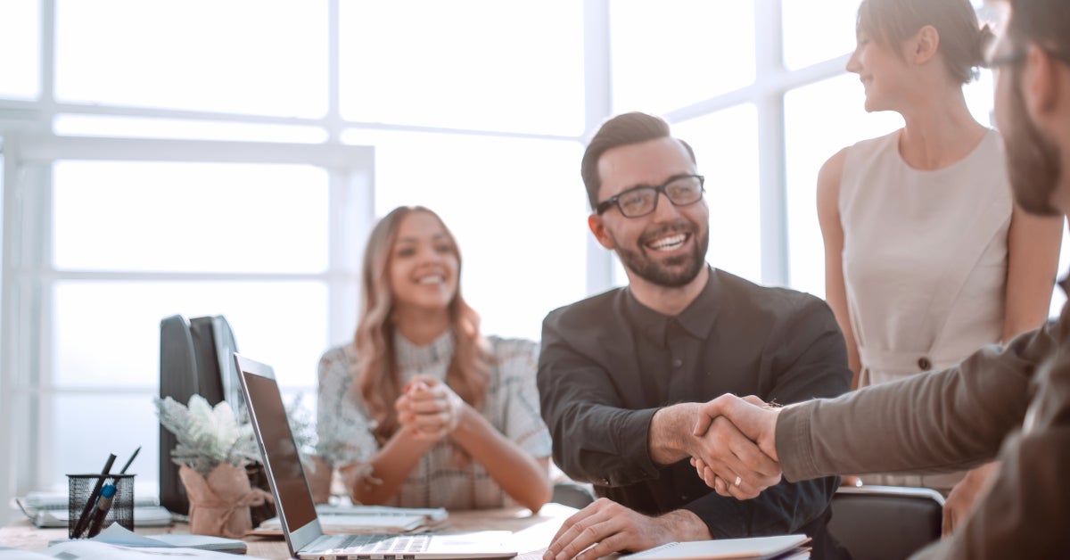 background image of the handshake of business partners in the office. business concept